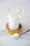 Yellow measuring tape, glass of delicious milky product.Vertical shot.Concept of proper nutrition