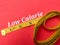 Yellow measuring tape with the word Low Calorie