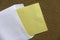 A yellow memo note and envelope on notice cork board. Copy space for text, logo