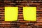 Yellow memo stick on brick wall background