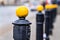 Yellow metal ball on street post, blurred city street