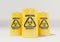Yellow metal barrels with black biohazard warning sign on white background