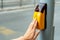 Yellow metal crosswalk button for pedestrian crossing signal for traffic rules in Europe. Close up of yellow pressing by young boy