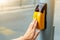 Yellow metal crosswalk button for pedestrian crossing signal for traffic rules in Europe. Close up of yellow pressing by young boy