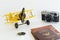 Yellow metal toy plane with travel objects on white