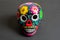 Yellow Mexican skull with painting  on black background