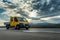 Yellow Mini Truck - Utility transportation van or mini truck driving on a highway
