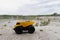 Yellow mining truck with stones at high mountain near quarry.