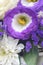 Yellow mites of a rose of an unusual color. Beautiful bouquet of white and purple flowers. Decorative flower arrangement for the
