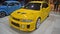 Yellow Mitsubishi Lancer evolution V in a car show