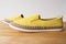Yellow moccasin shoes on wooden table