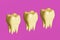 Yellow molar teeth on pink background