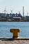 yellow mooring bollard number 1 next to a river