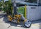 Yellow motorcycle chopper parked on a sidewalk