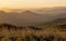 Yellow Mountaintop layers as the sun drops below the skyline.