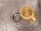 A yellow mug is filled with water and sits in a gray sink