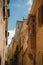 Yellow narrow medieval street with typical maltese balcony in Mdina, ancient capital of Malta, fortified medieval town. Popular