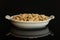 Yellow natural peanut isolated on black glass