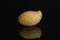 Yellow natural peanut isolated on black glass