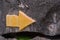 Yellow navigation symbol on the rock wall of a natural mountain, Limestone mountains,to the right