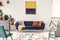 Yellow and navy blue painting above sofa in modern living room i