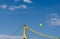 Yellow   net filet beach volley ball  against blue sky .  Relaxing activities on vacation at the sea