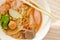 Yellow noodles with squid and fish ball in red soup Chinese-language called Yong Tau Fu