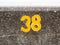 A yellow numbering with paint on sea front wall Harwich 38