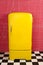 Yellow old vintage retro refrigerator on a pink background