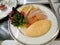 Yellow omelet,bacon with salad and crispy potato chips in white plate