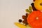 Yellow and orange pumpkinscorn, cones and autumn leaves on white wooden background for harvest fall and thanksgiving theme. cornuc