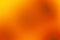 Yellow orange red fiery golden brown black abstract background. Color gradient. Rough, grain, noise.