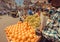 Yellow oranges on marketplace for sell and some customers of busy asian street market