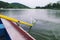 Yellow paddle in the water. Boating on river. Oar of boat touching water