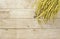 Yellow paddy jasmine rice on wood background