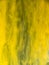 Yellow paint dissolving into water, abstract background. Close up view. Blurred background. Acrylic flows mixing with