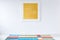 Yellow painting on white wall in colorful interior with carpet.