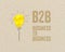 Yellow paper light bulb with B2B - Business to business on brown recycled paper background