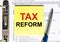 Yellow paper with text Tax Reform