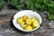 Yellow paradise apples in a bowl on wooden  in garden