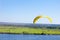 Yellow Paraglider in blue sky above the river and riverside. Bird`s eye panorama. Tom river. Tomsk city, Russia