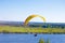 Yellow Paraglider in blue sky above the river and riverside. Bird`s eye panorama. Tom river. Tomsk city, Russia