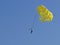 yellow paragliding in the blue sky