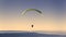 Yellow paragliding on pastel sky
