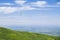 Yellow paraplane in blue sky over mountains