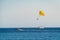 Yellow parasailing over the sea