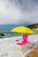 Yellow parasol and pink chair at the beach
