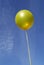 Yellow party balloon on blue sky