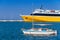 Yellow passenger ferry and small fishing boat