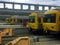 Yellow passenger trains waiting for departure from the dead end train station